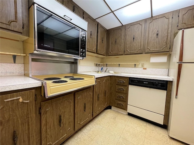 kitchen with light tile patterned floors and white appliances