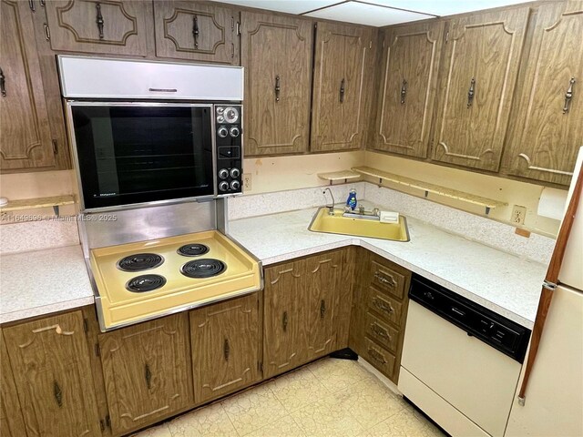 3000 NE 5th Ter Unit 310-A, Wilton Manors, FL 33334 - kitchen featuring white dishwasher, stovetop, oven, and light countertops