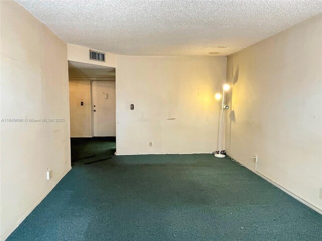3000 NE 5th Ter Unit 310-A, Wilton Manors, FL 33334 - empty room with carpet floors and a textured ceiling