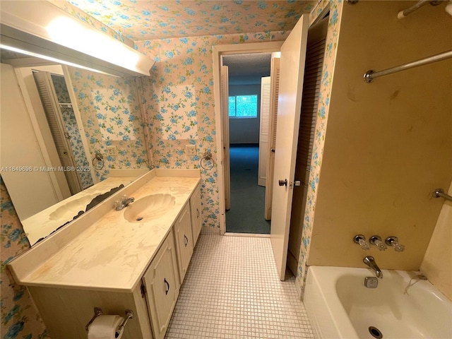 3000 NE 5th Ter Unit 310-A, Wilton Manors, FL 33334 - full bath with wallpapered walls, vanity, shower / bathtub combination, and tile patterned flooring