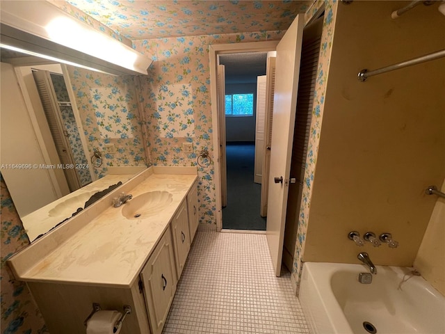 bathroom featuring vanity, a bathing tub, and tile patterned flooring