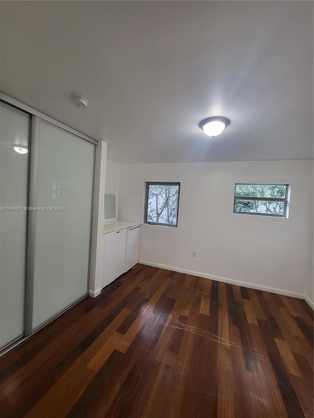 unfurnished room featuring dark hardwood / wood-style floors