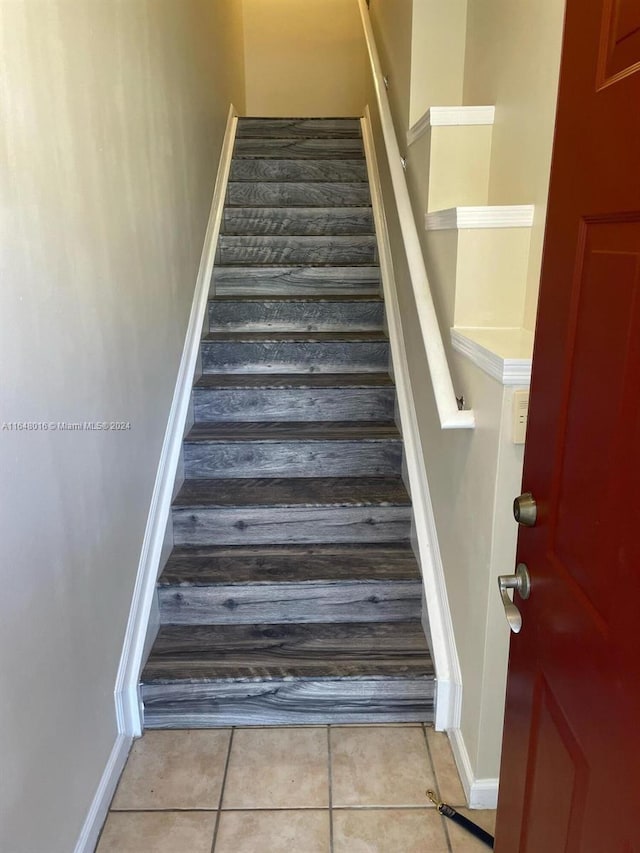 stairs featuring tile patterned floors