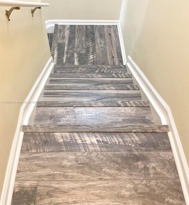 stairs featuring wood-type flooring