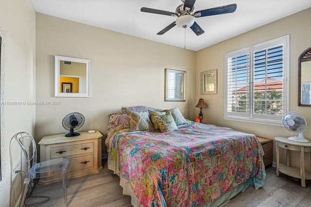 bedroom with hardwood / wood-style flooring and ceiling fan