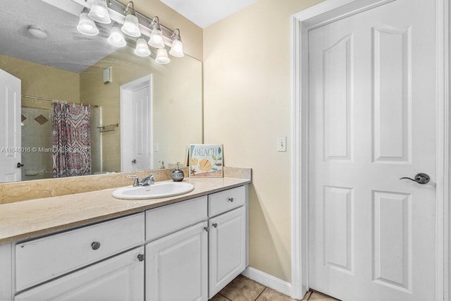 bathroom with tile patterned flooring, walk in shower, and vanity