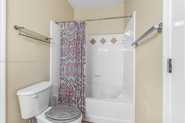 bathroom with a textured ceiling, toilet, and shower / bath combination with curtain