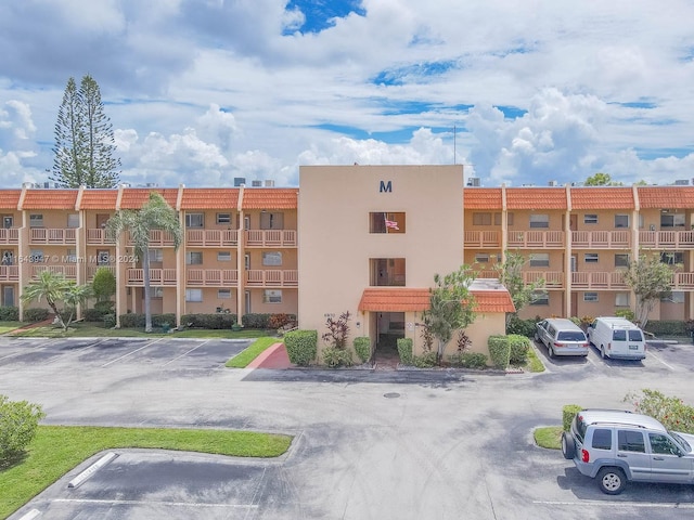 view of property featuring uncovered parking