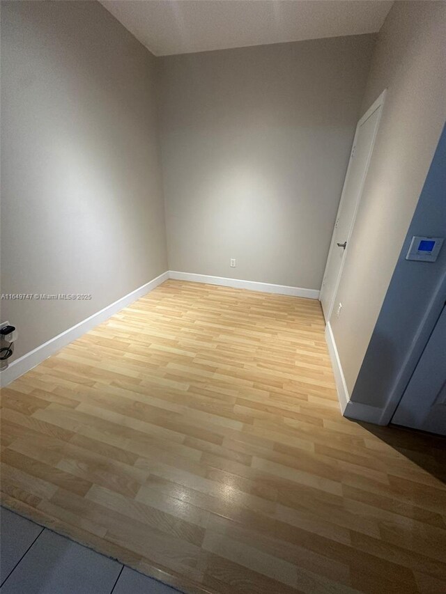 unfurnished room with light wood-type flooring