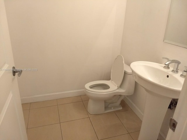 bathroom with tile patterned flooring and toilet