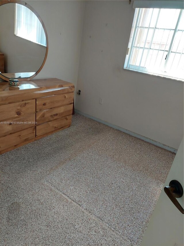 unfurnished bedroom with carpet flooring