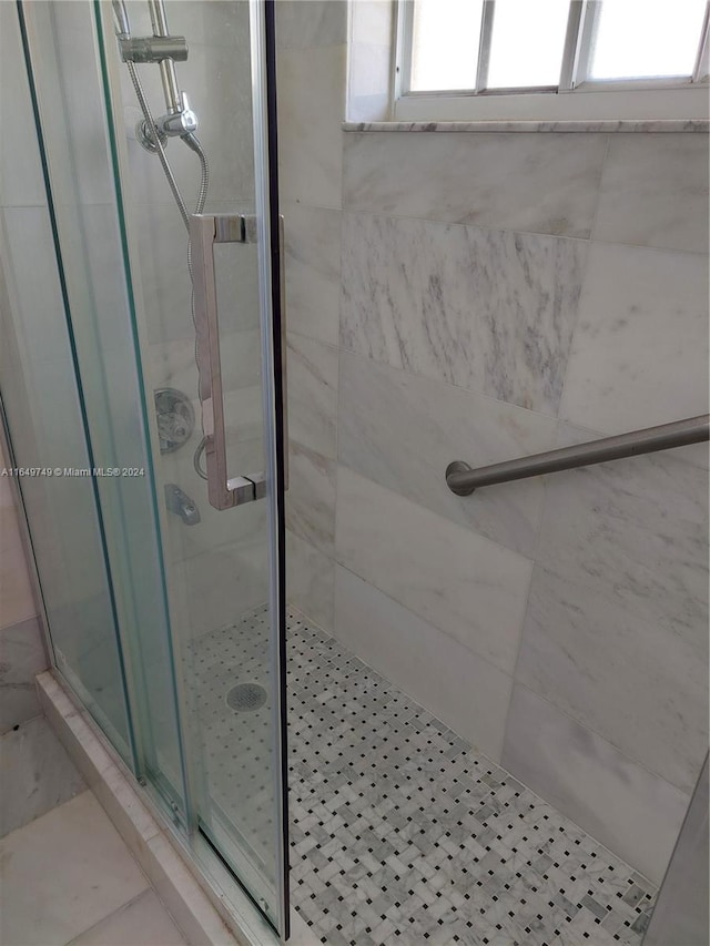 bathroom with a shower with shower door