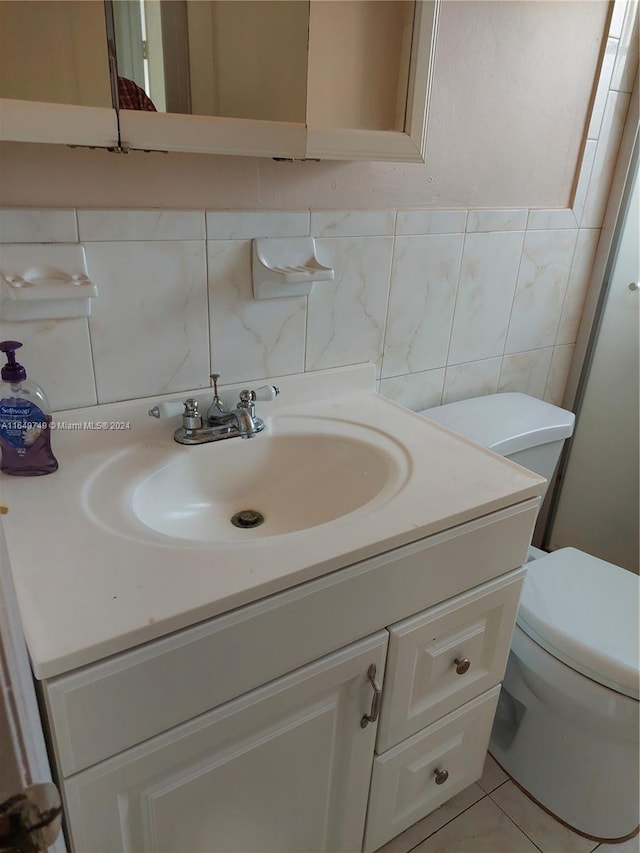 bathroom featuring tile walls, tile patterned flooring, backsplash, vanity, and toilet