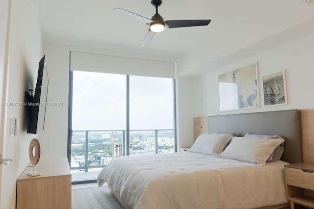 bedroom featuring hardwood / wood-style flooring, access to outside, and ceiling fan