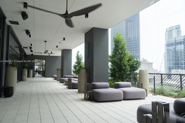 wooden deck featuring a view of city, a patio, and a ceiling fan