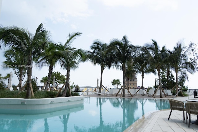 community pool with a patio area