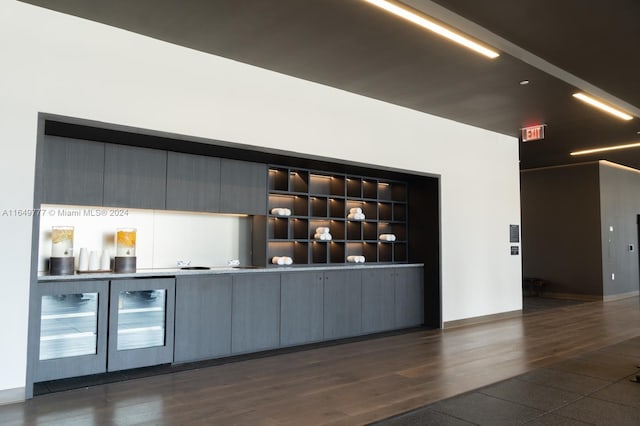 bar with built in shelves, dark hardwood / wood-style floors, gray cabinets, and wine cooler