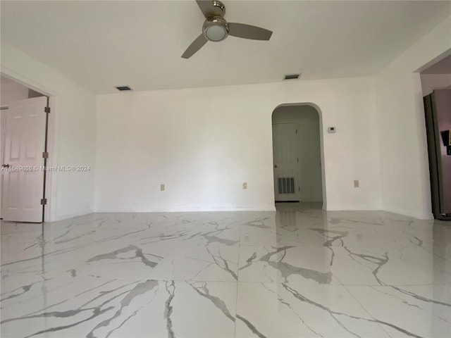 spare room with light tile patterned floors and ceiling fan