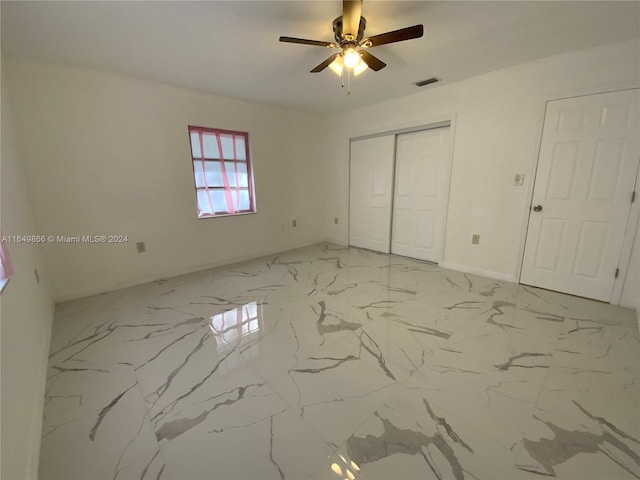 unfurnished bedroom featuring a closet, ceiling fan, and light tile patterned flooring