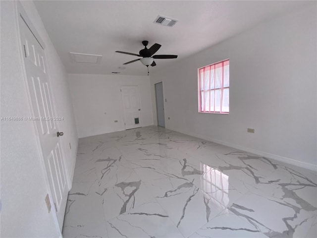 empty room featuring ceiling fan and light tile patterned floors