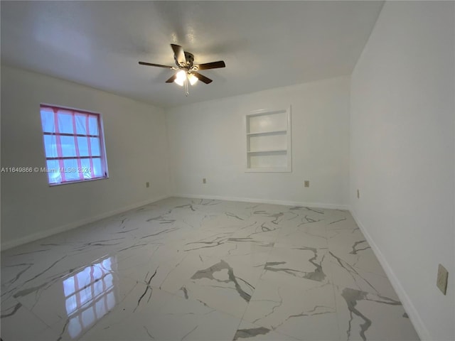 unfurnished room with built in features, ceiling fan, and light tile patterned floors