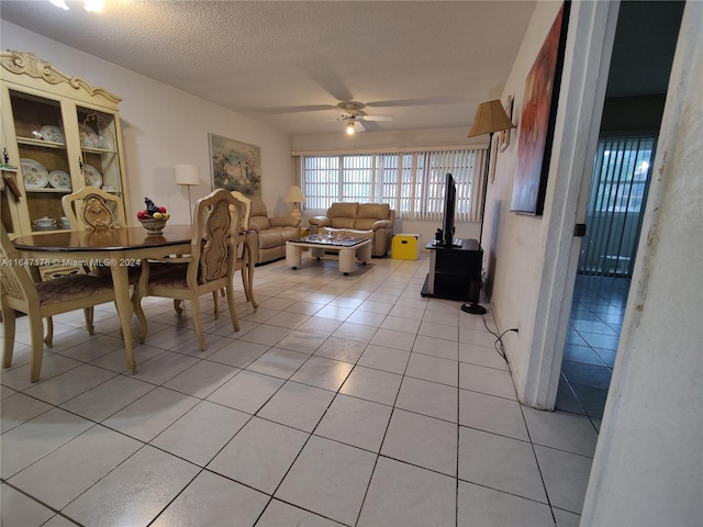 tiled dining area featuring ceiling fan and a textured ceiling