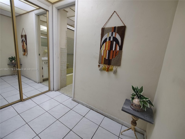 corridor featuring light tile patterned floors