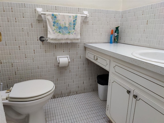 bathroom with vanity, tile walls, toilet, and tile patterned floors