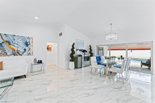 tiled dining room with an inviting chandelier and high vaulted ceiling