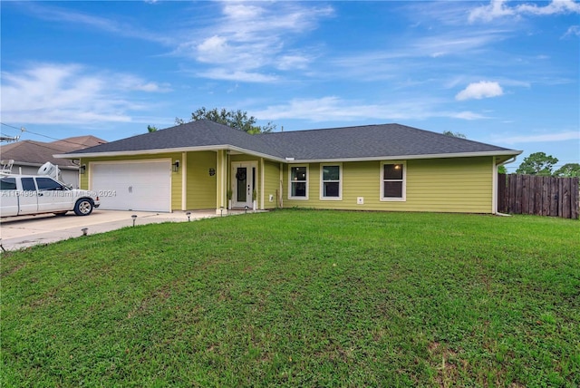 ranch-style house featuring a garage and a front lawn