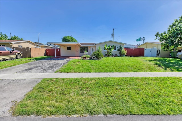 ranch-style home with a carport and a front yard