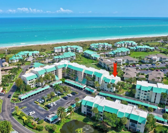 birds eye view of property with a view of the beach and a water view