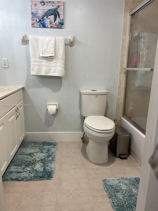 bathroom featuring tile patterned flooring, toilet, and vanity