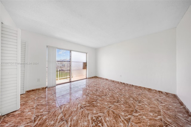 spare room featuring a textured ceiling