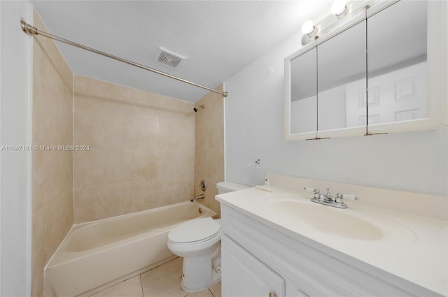 full bathroom with vanity, tiled shower / bath, tile patterned flooring, toilet, and a textured ceiling