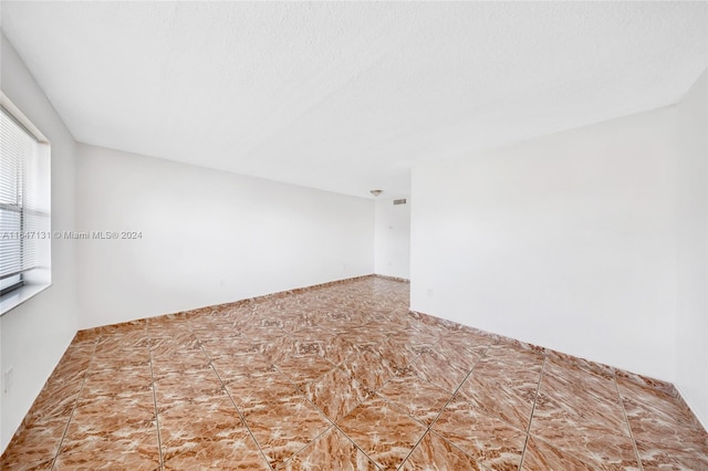 empty room with a textured ceiling