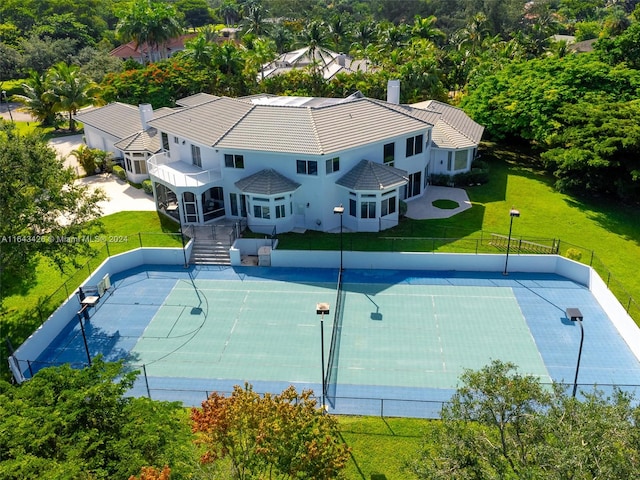 view of sport court featuring a yard