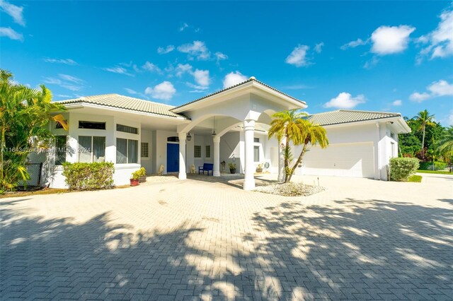 mediterranean / spanish-style home with a garage