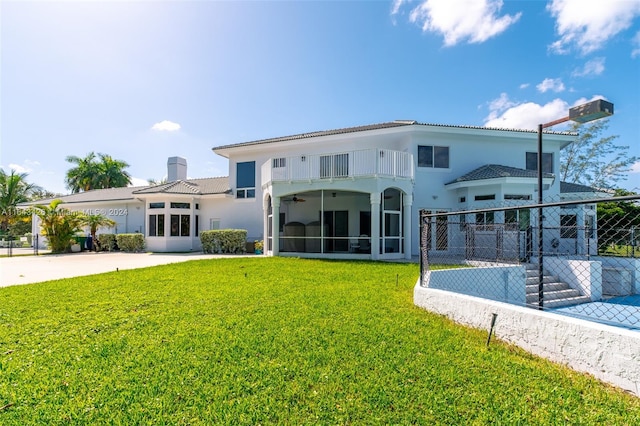 exterior space featuring a balcony and a lawn