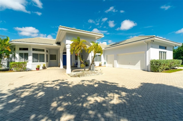 mediterranean / spanish-style house with a garage