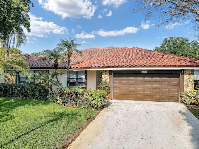 view of front of home with a front yard and a garage