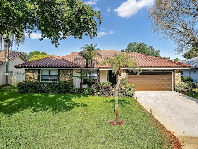 view of front of home featuring a front yard and a garage