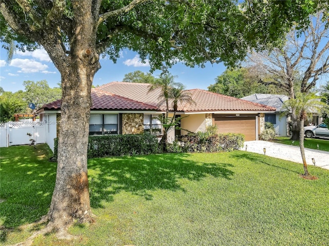 view of front of home with a garage and a front lawn