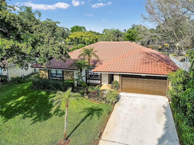 view of front of home featuring a garage and a front lawn