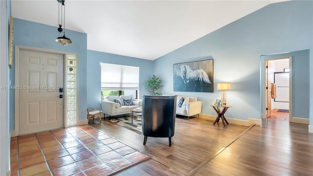 foyer entrance featuring high vaulted ceiling and hardwood / wood-style flooring