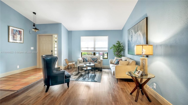 sitting room featuring lofted ceiling and wood-type flooring