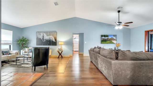 living room with light wood-type flooring, vaulted ceiling, and ceiling fan