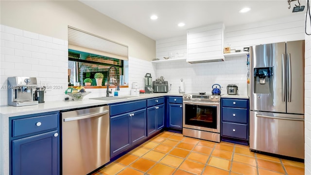 kitchen featuring decorative backsplash, stainless steel appliances, custom exhaust hood, sink, and blue cabinets