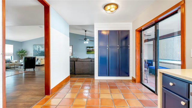 foyer entrance with light wood-type flooring, vaulted ceiling, a wealth of natural light, and ceiling fan