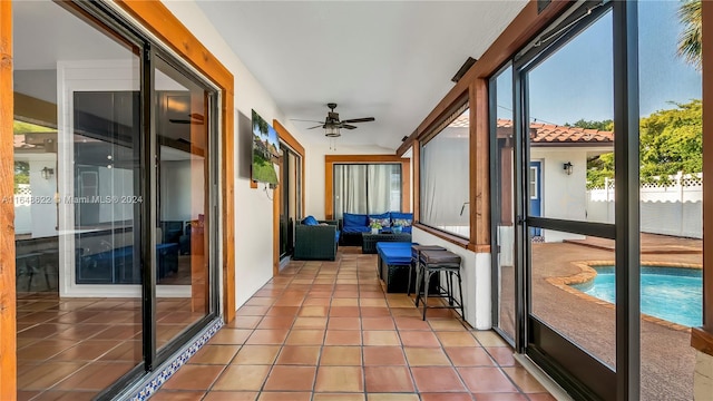 unfurnished sunroom featuring ceiling fan